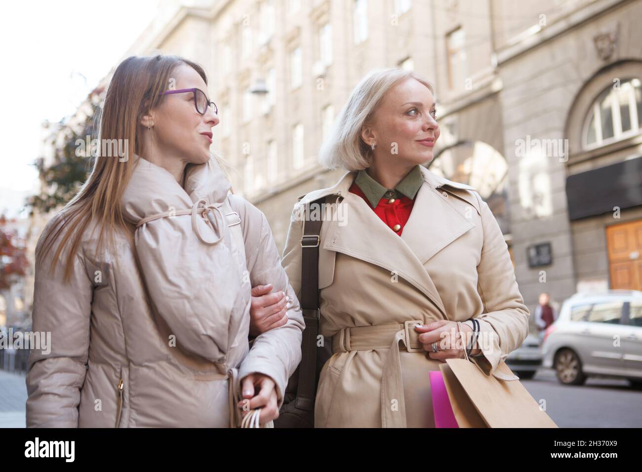 Low angle shot of two mature women sightseeing in city center Stock ...
