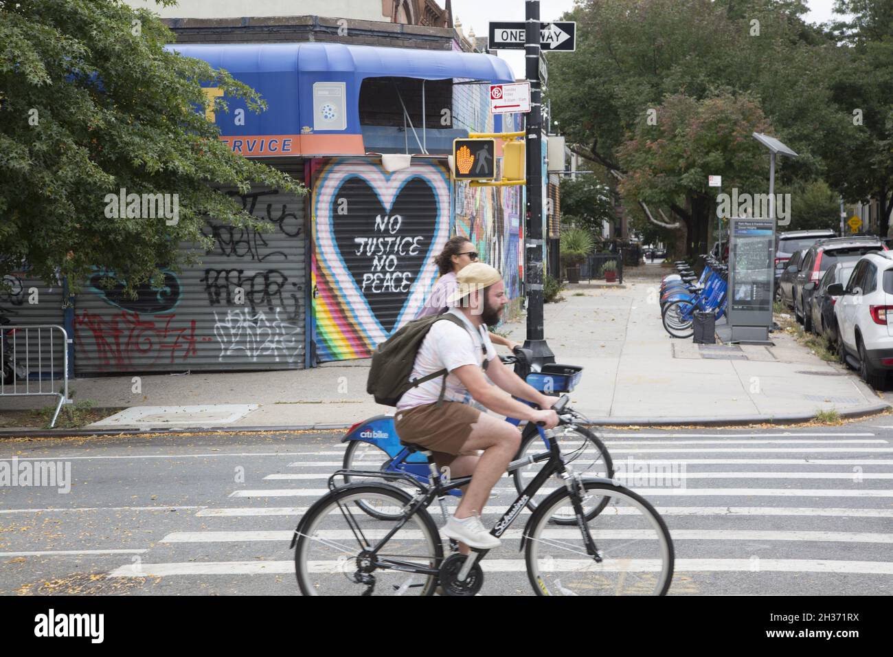 Bikers ride along Franklin Avenue in the Crown Heights neighborhood of Brooklyn, New York. Stock Photo