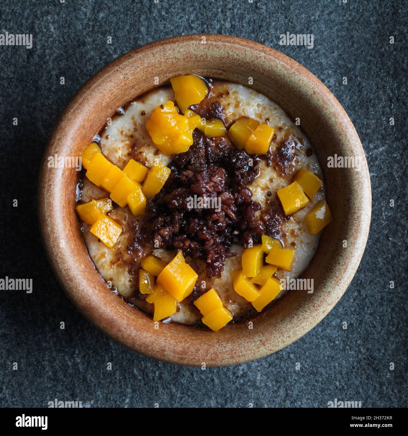 Healthy breakfast porridge with steel cut oats, black sticky rice