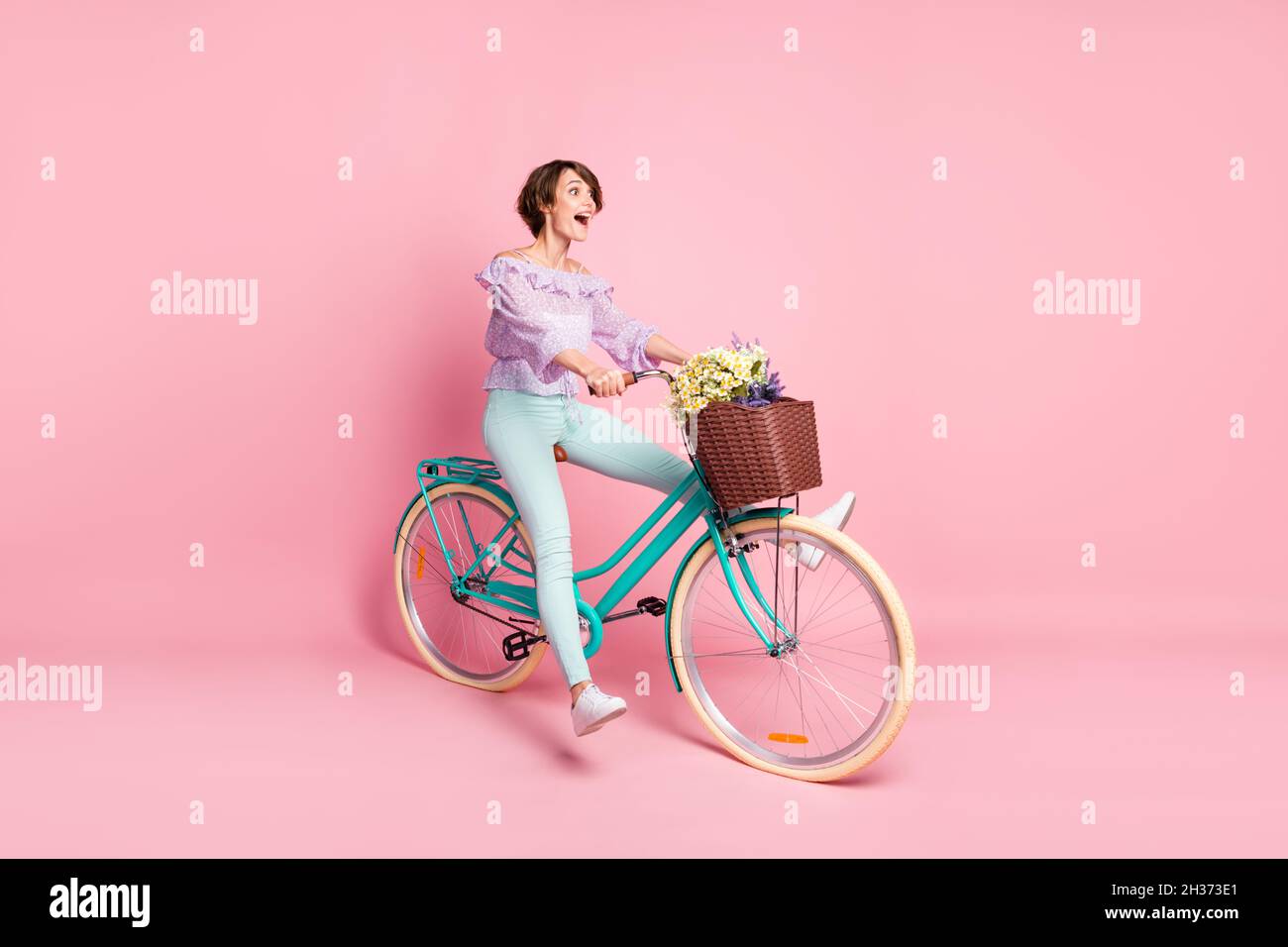 Full size profile side photo of young happy excited crazy shocked girl  riding bicycle isolated on pink color background Stock Photo - Alamy