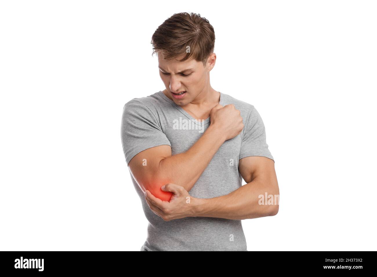 Sad young caucasian guy athlete suffering from elbow pain, presses hand