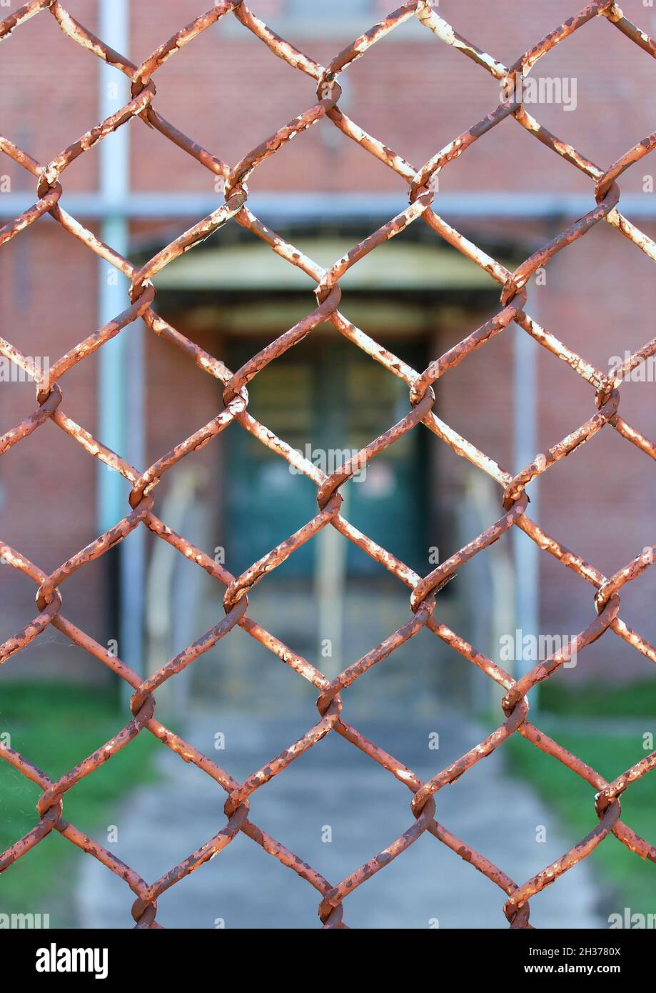 Rusted chainlink fence surrounding the former Bemis Cotton Mill, Bemis Tennessee Stock Photo