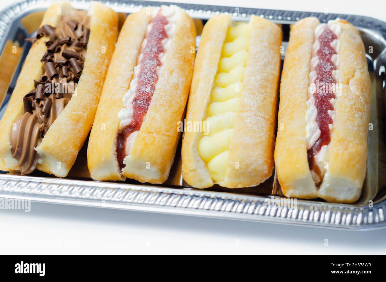 Mixed finger donuts filling chocolate, custard, jam and whipped cream