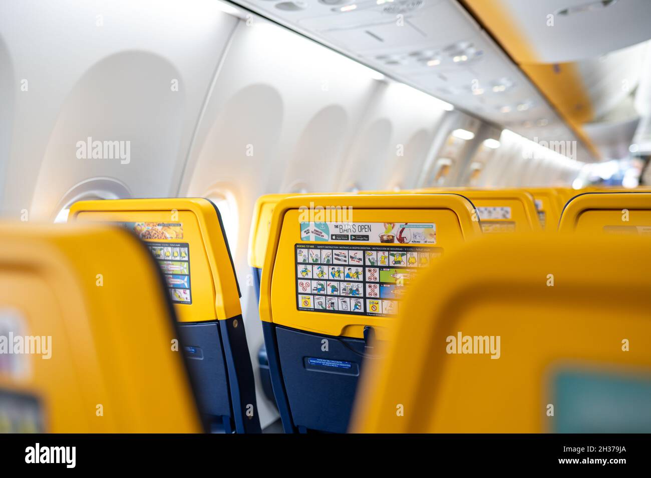 Ryanair empty seats with safety instruction. Airplane interior view. No people, selective focus. Ryanair is an Irish low-cost airline. Birmingham, the UK - October 14, 2021 Stock Photo
