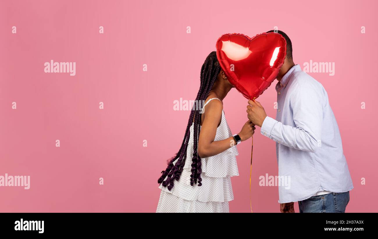 Romantic Black Couple Kissing Hiding Behind Red Heart Balloon Stock ...