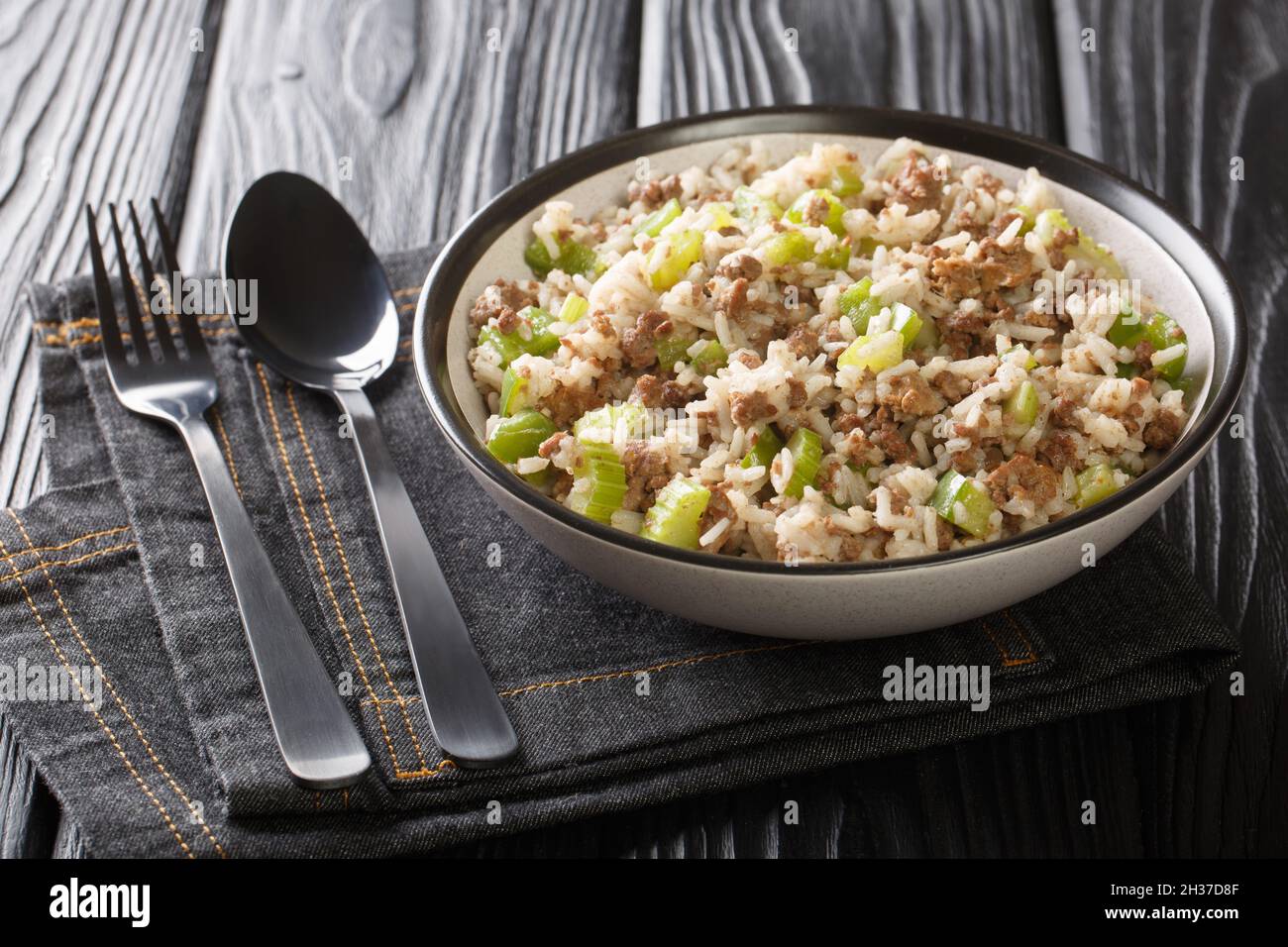 Dirty Rice is a delicious savory classic Cajun dish that gets its flavor from ground meat, cajun seasonings, and aromatic vegetables close-up in a pla Stock Photo