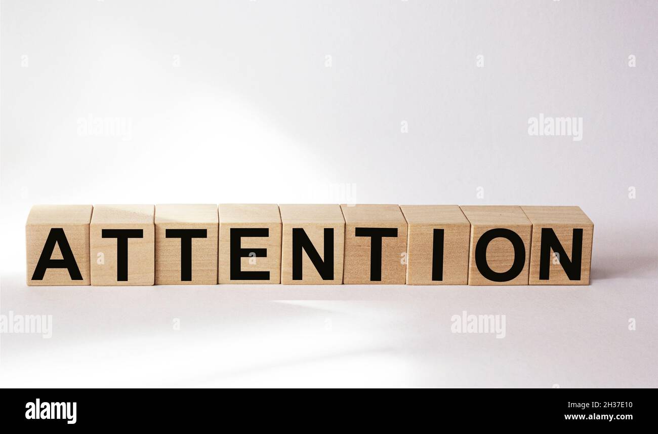 Attention word consisting of building blocks on white background Stock Photo