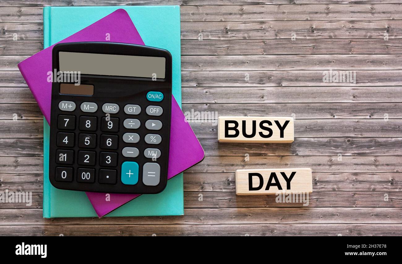 text on busy day blocks and wooden background Stock Photo
