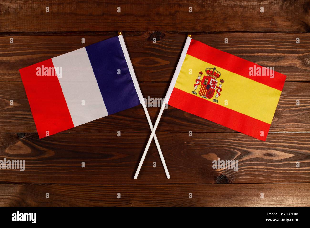 Flag of France and flag of Spain crossed with each other. France vs Spain Stock Photo