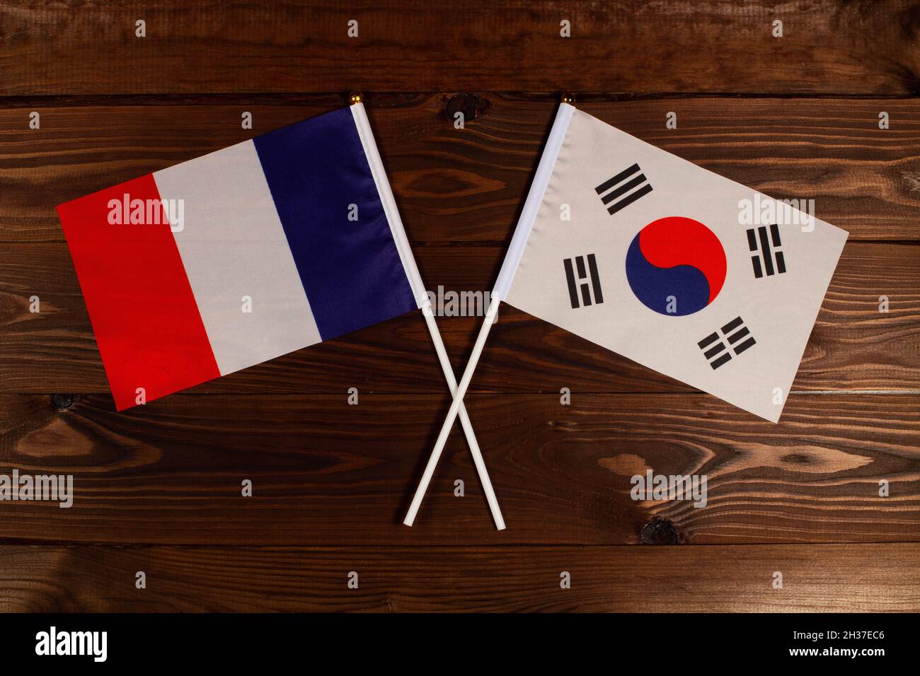 Flag of France and flag of South Korea crossed with each other. France vs South Korea Stock Photo