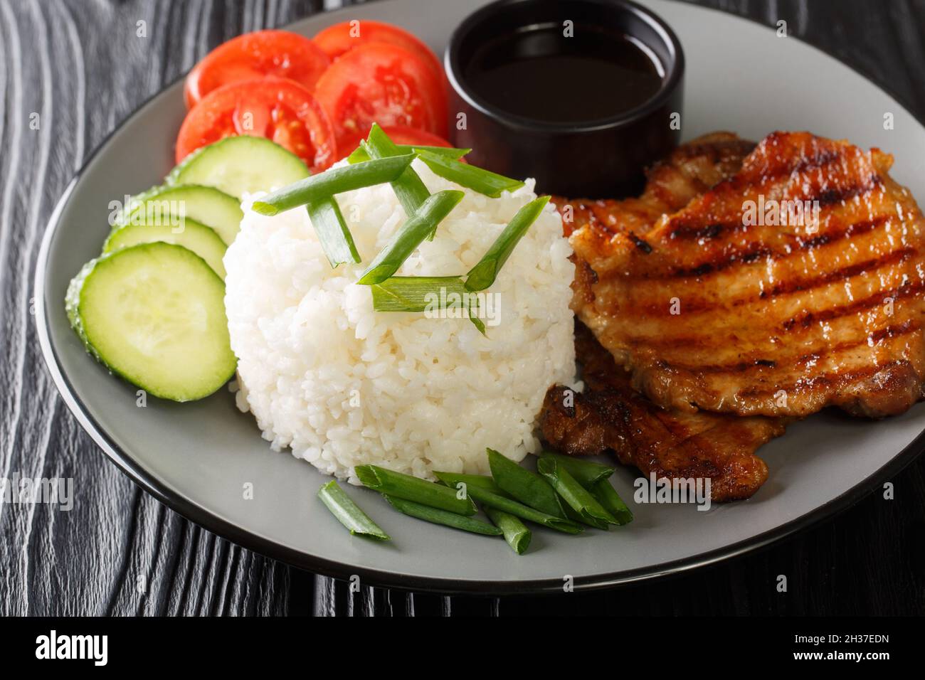 Broken rice with pork chop Vietnamese recipes closeup in a plate on