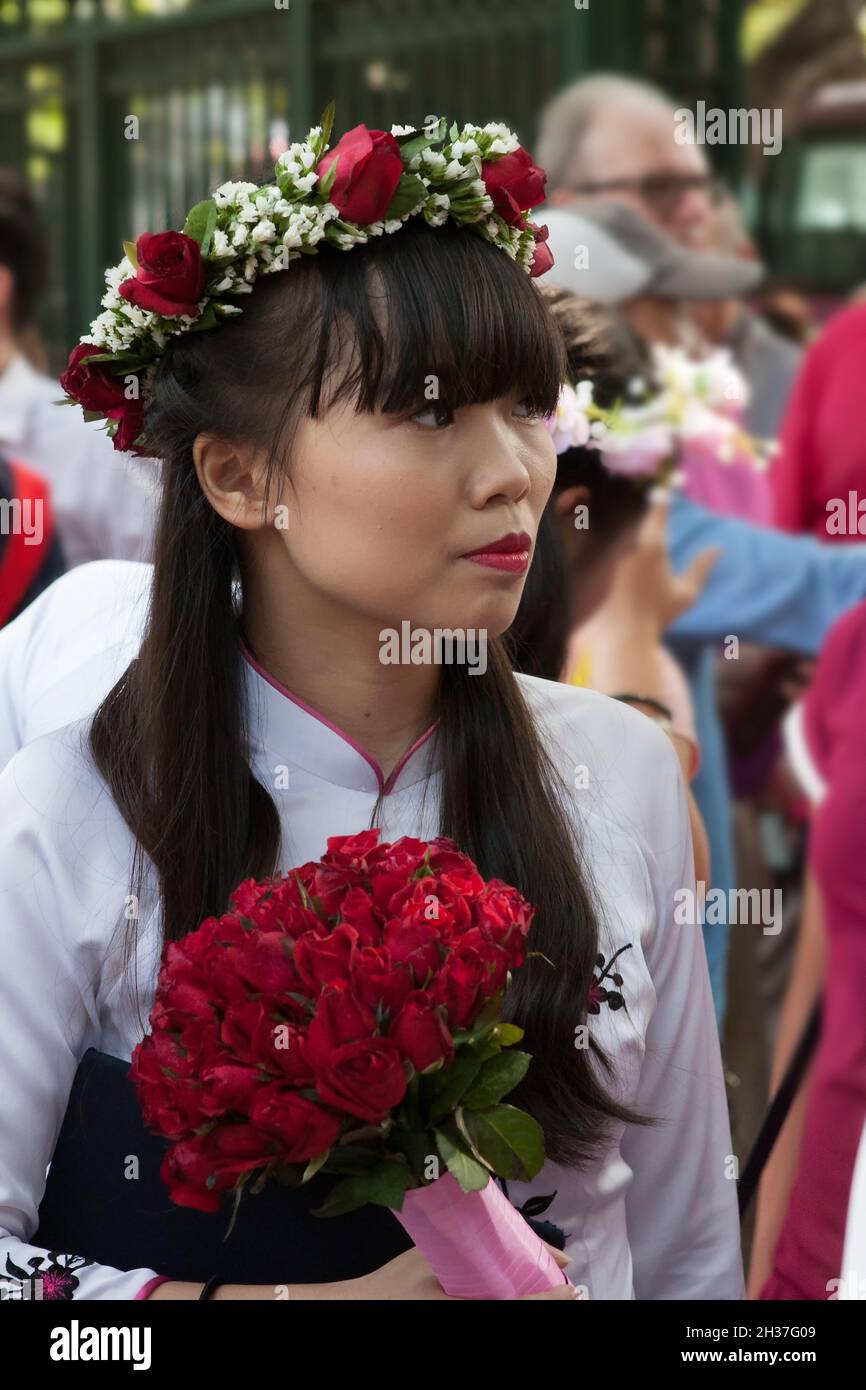 Young female visitor to a student graduation ceremony at the Temple of Literature (Văn Miếu), Đống Đa, Hanoi, Viet Nam Stock Photo
