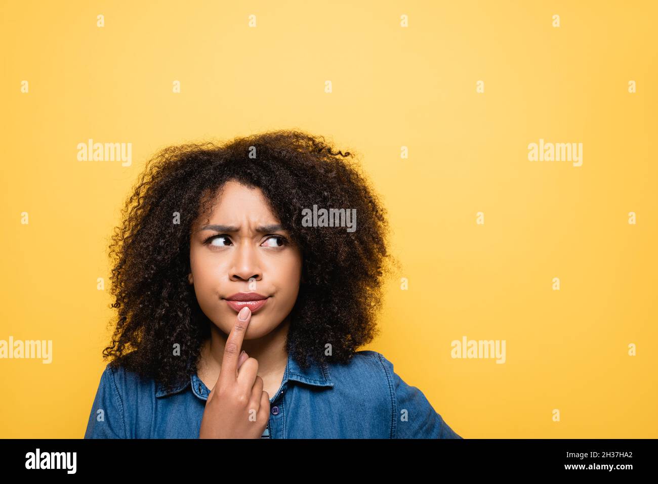 Thoughtful woman touching lips hi-res stock photography and images - Alamy