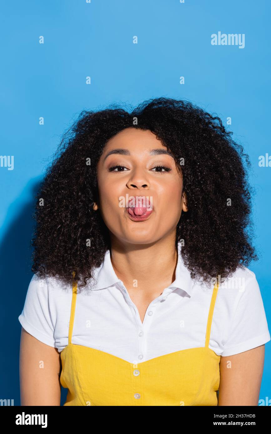 african american woman looking at camera and sticking out tongue on ...
