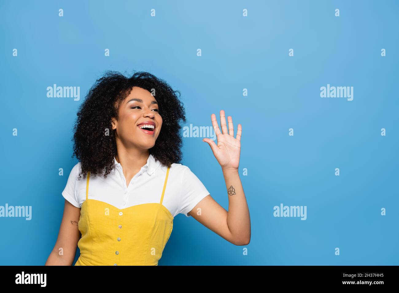 Happy african woman waving hand hi-res stock photography and images - Alamy