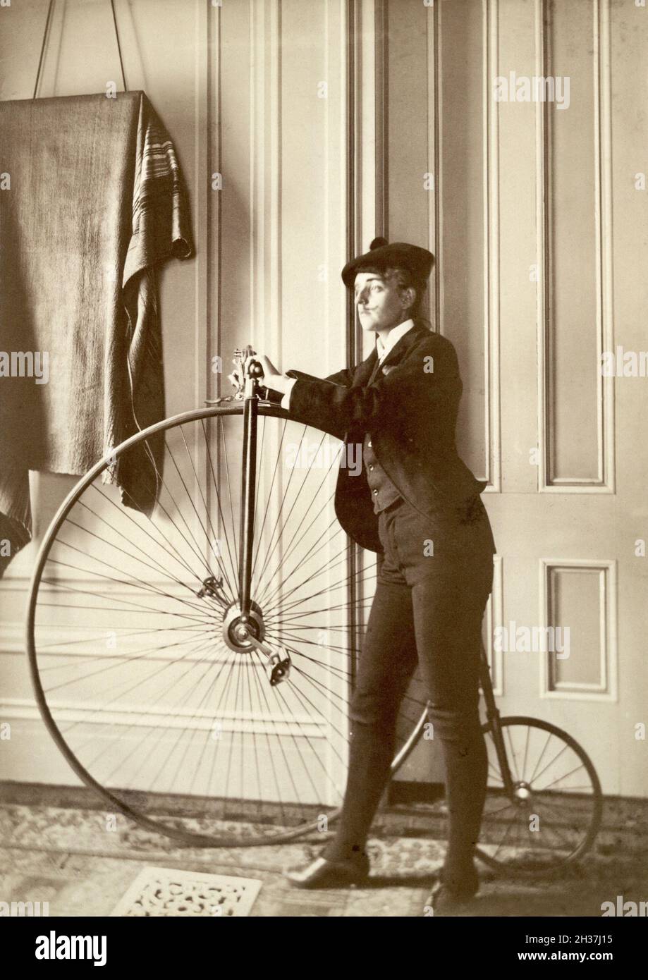 Frances Benjamin Johnston vintage photography - Self-portrait with false moustache and penny-farthing - 1880-1900 Stock Photo