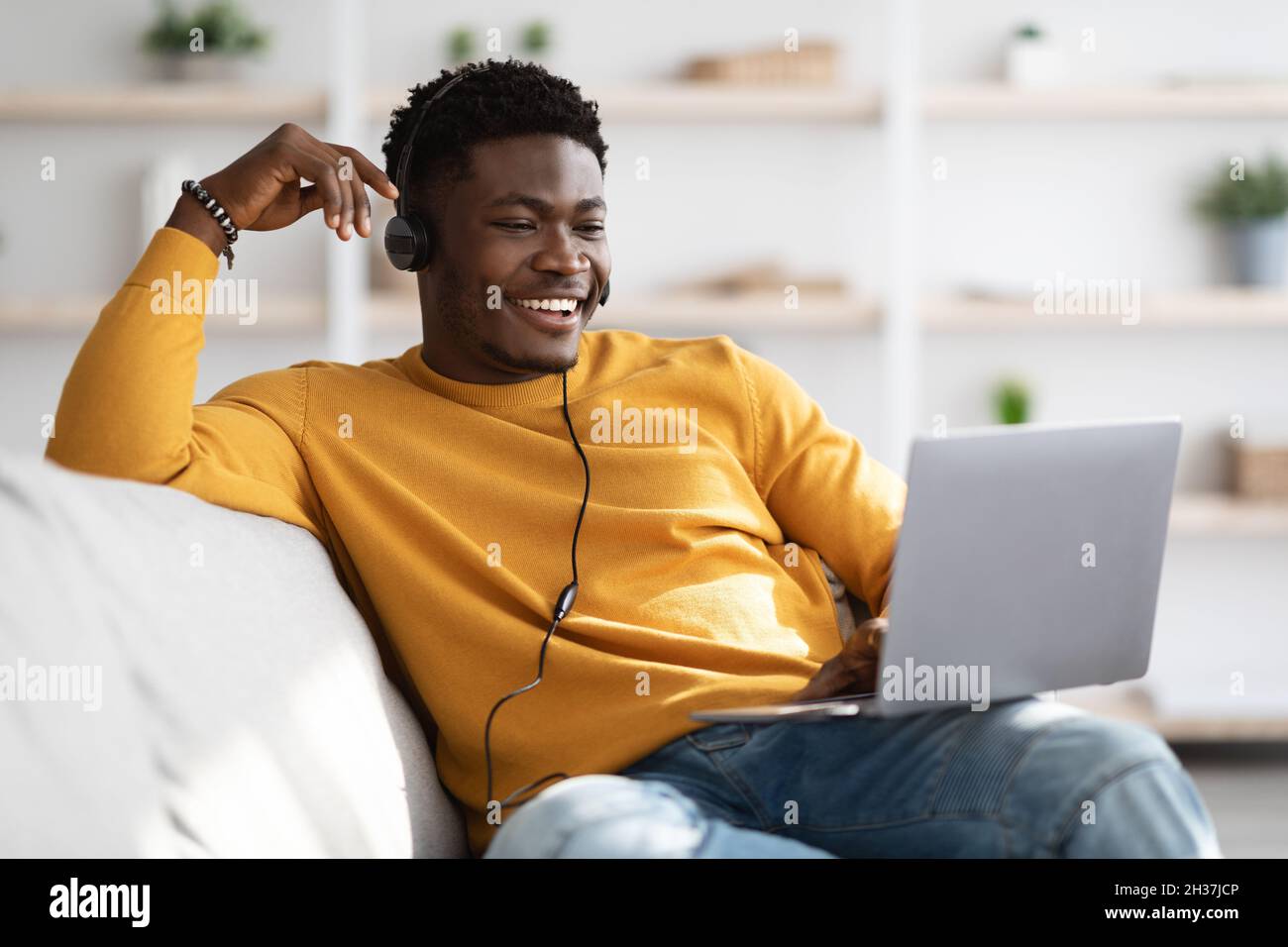 Handsome black guy having video call, using laptop Stock Photo