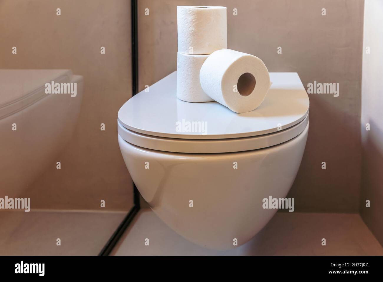Toilet paper rolls. Three white hygiene tissue napkins stacked on a