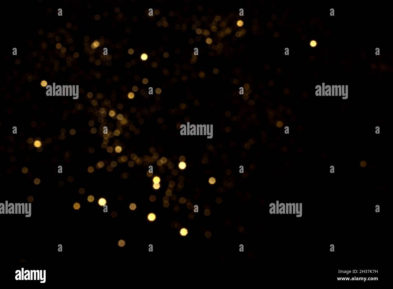 Golden blurred bokeh lights on black background. Glitter sparkle stars ...