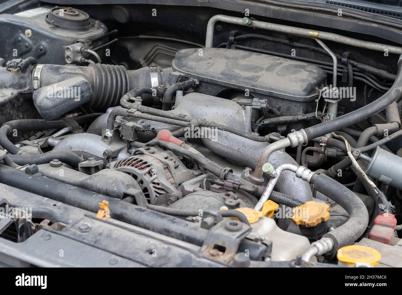 Dusty details of a flatfour (boxer) car engine compartment under the