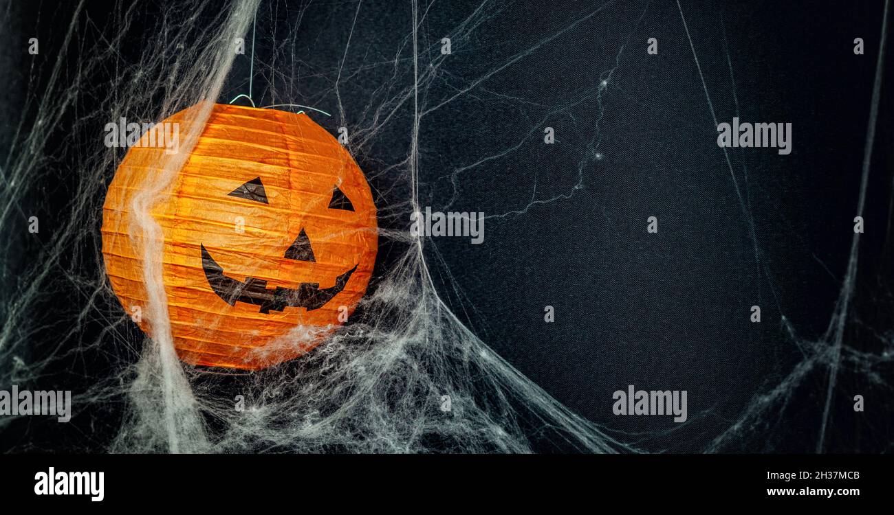 Jack o 'lantern on black background with cobwebs. Image with copyspace suitable for customization. Stock Photo