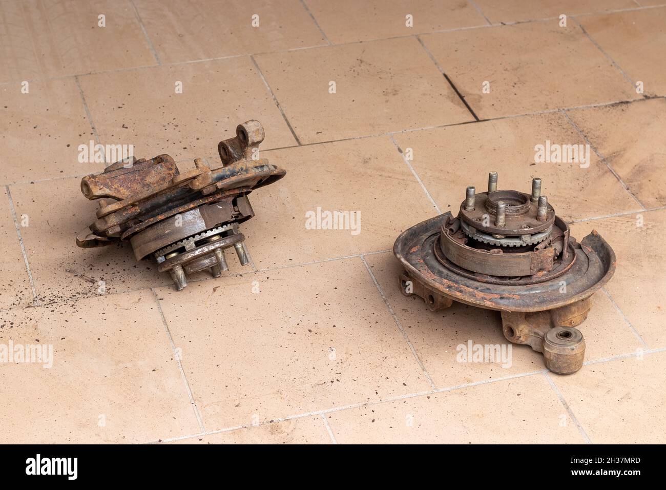Two old, used, rusty rear hubs, on which the brake pads of the parking