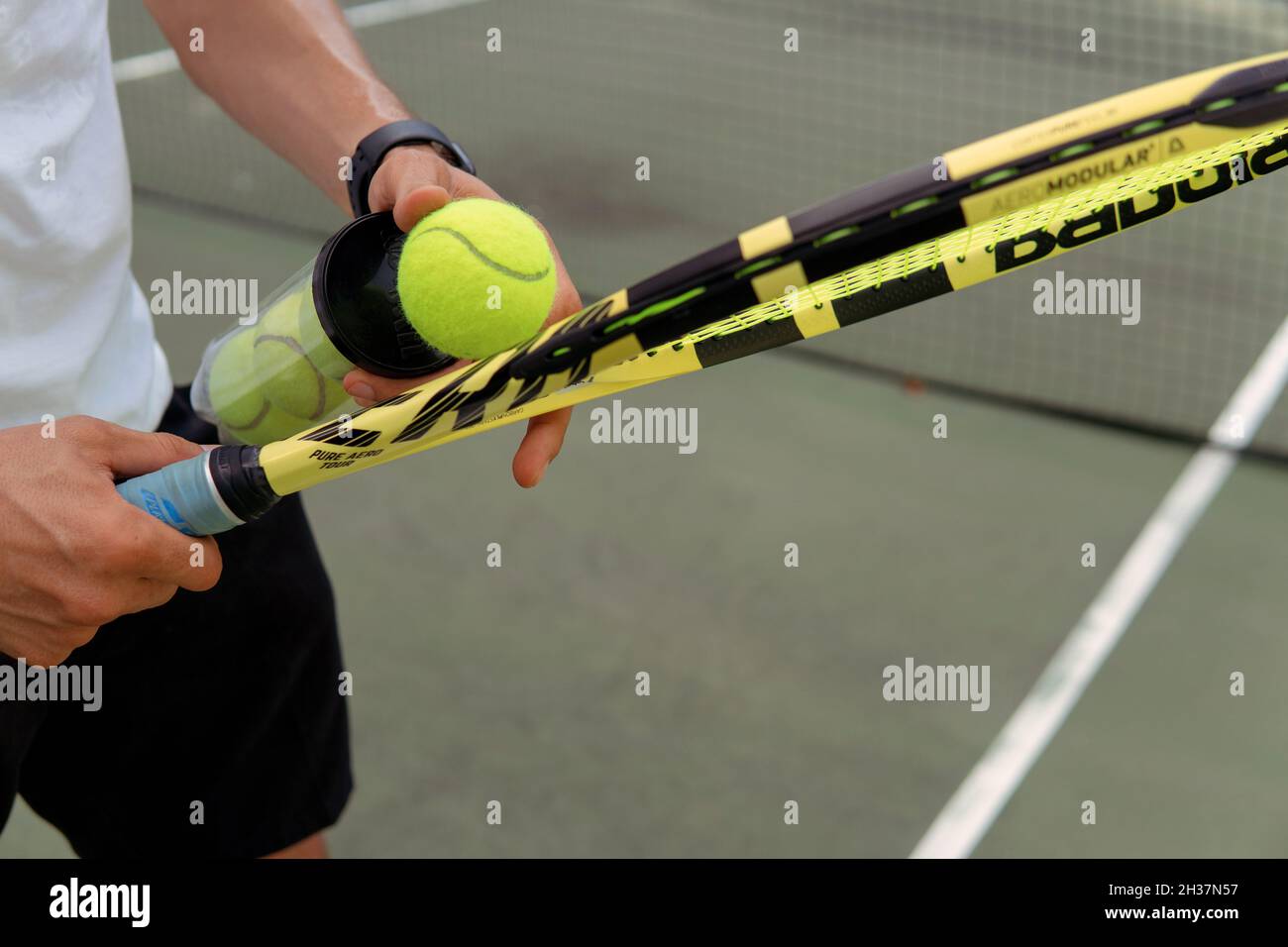 close-up. male hands holding tennis racket and balls. bali Stock Photo