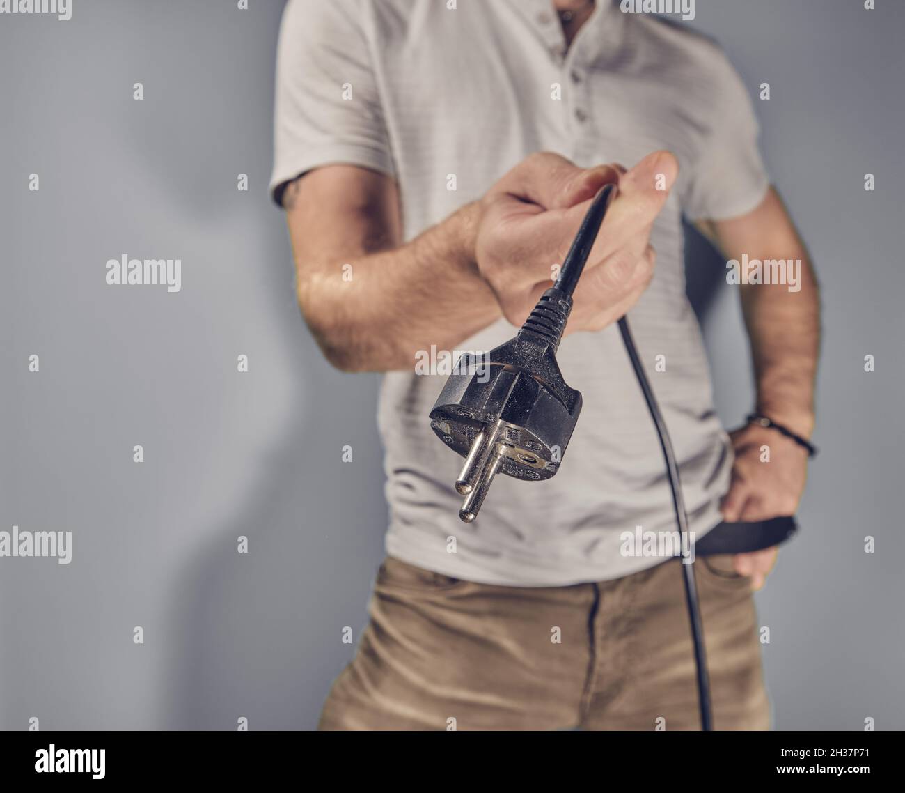 Man holding electricity plug in hand Stock Photo Alamy