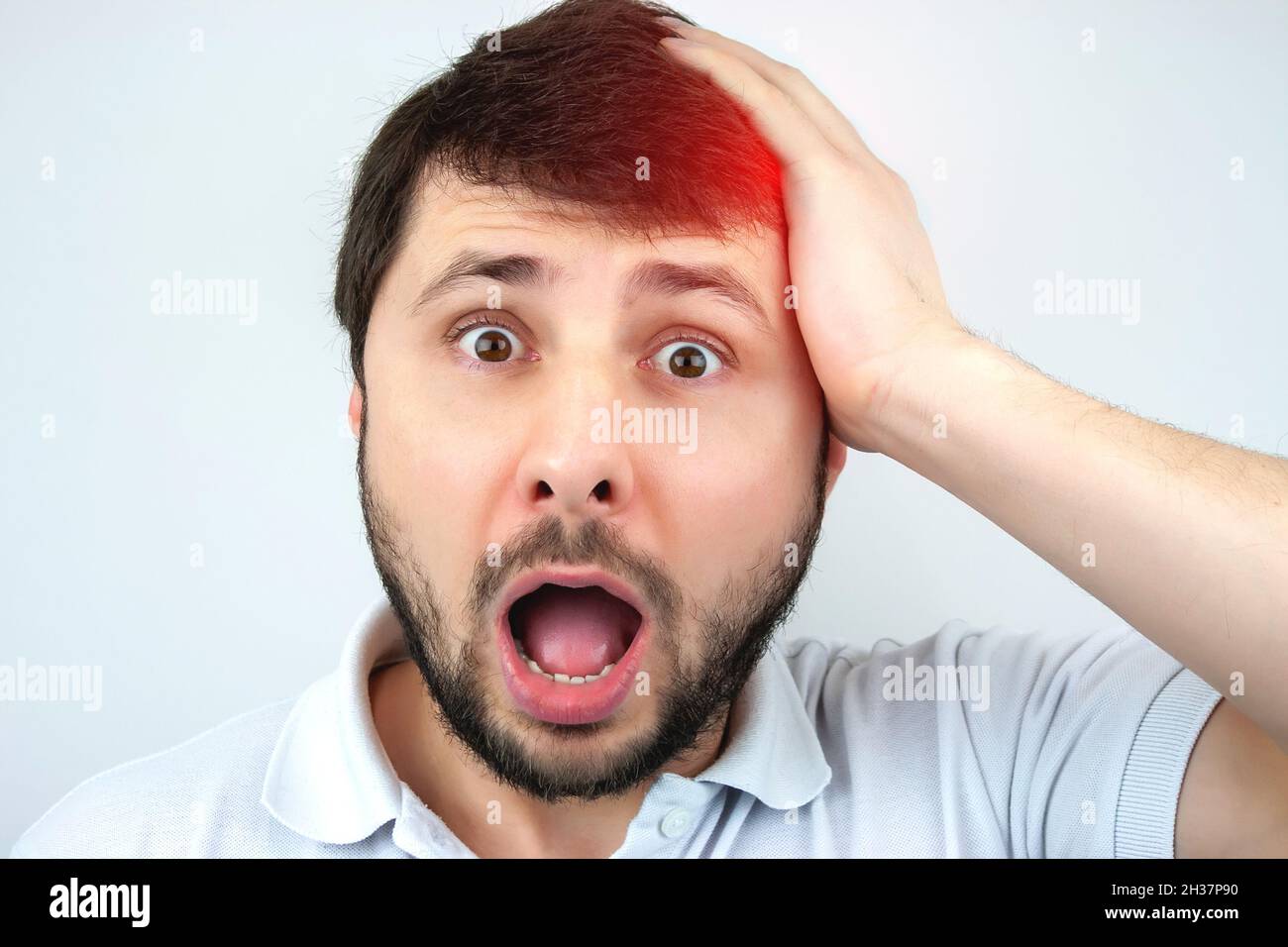 Portrait of young surprised emotional big eyes man with open mouth got  great idea and pointing with finger up on white background Stock Photo -  Alamy