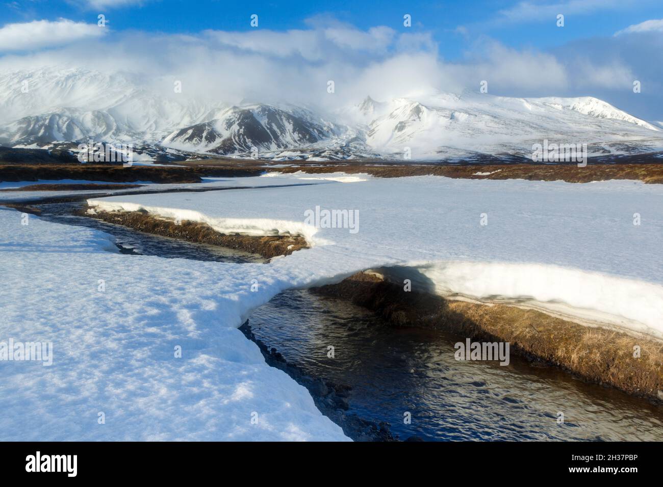 Scenic winter view with a snow bridge looking towards the Snæfellsjockull mountain range on the Snæfellsnesnes peninsula in Western part of Iceland Stock Photo