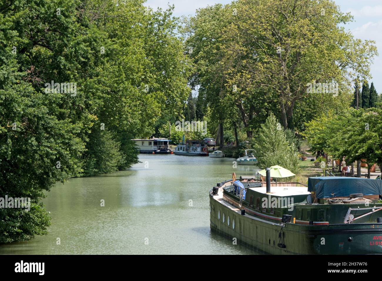 Boats on the Canal du Midi in the department of Aude, region of Occitanie, southern France. French water canal and waterway for holidays on barge Stock Photo