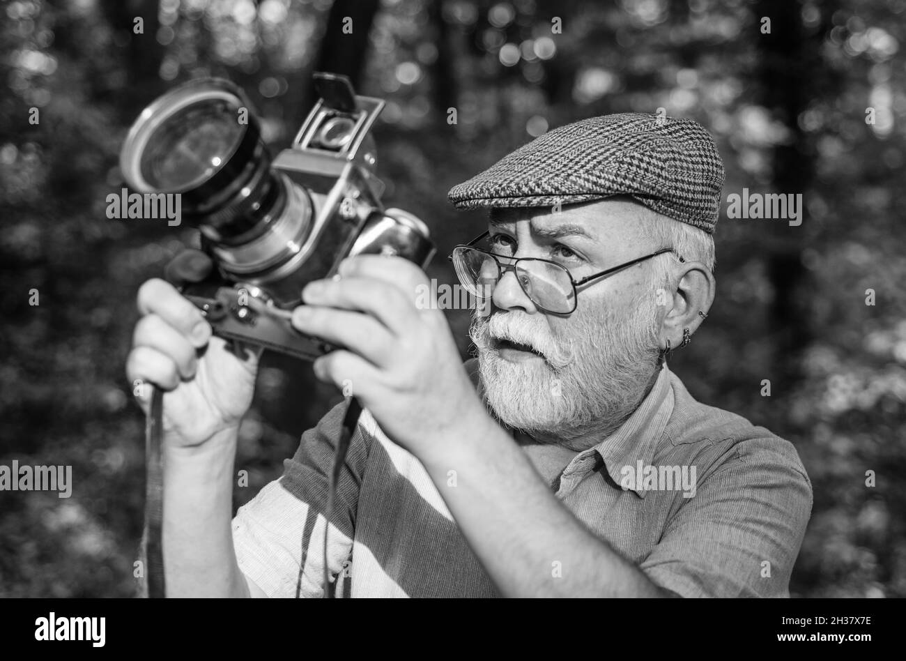 Pension hobby. Experienced photographer. Vintage camera. Old man shoot nature. Professional photographer. Make perfect frame. Landscape nature photo Stock Photo