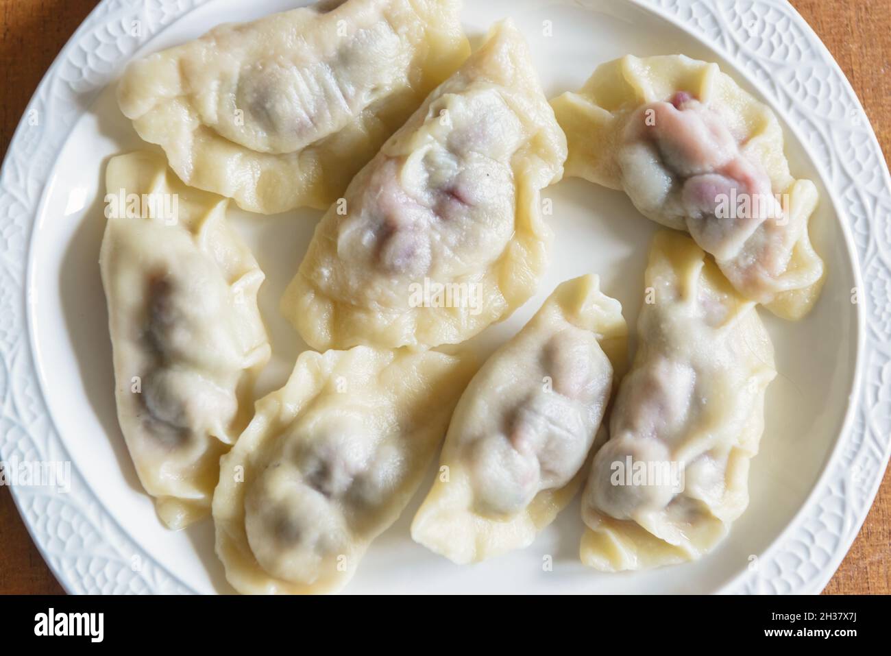 Fresh dumplings with cherry filling on a plate Stock Photo
