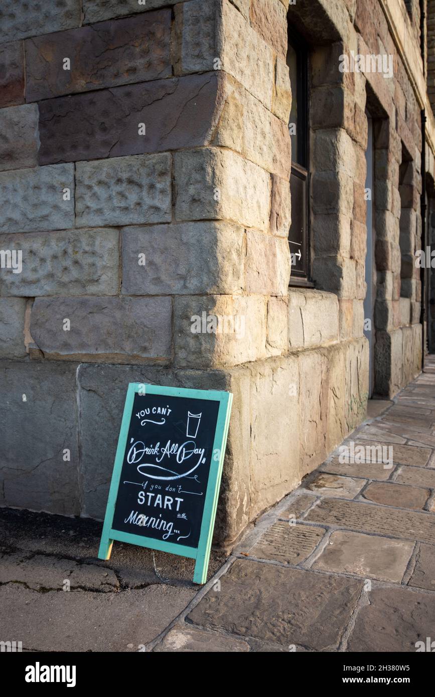 A chalkboard sign propped up against a building wall in Bristol Stock Photo