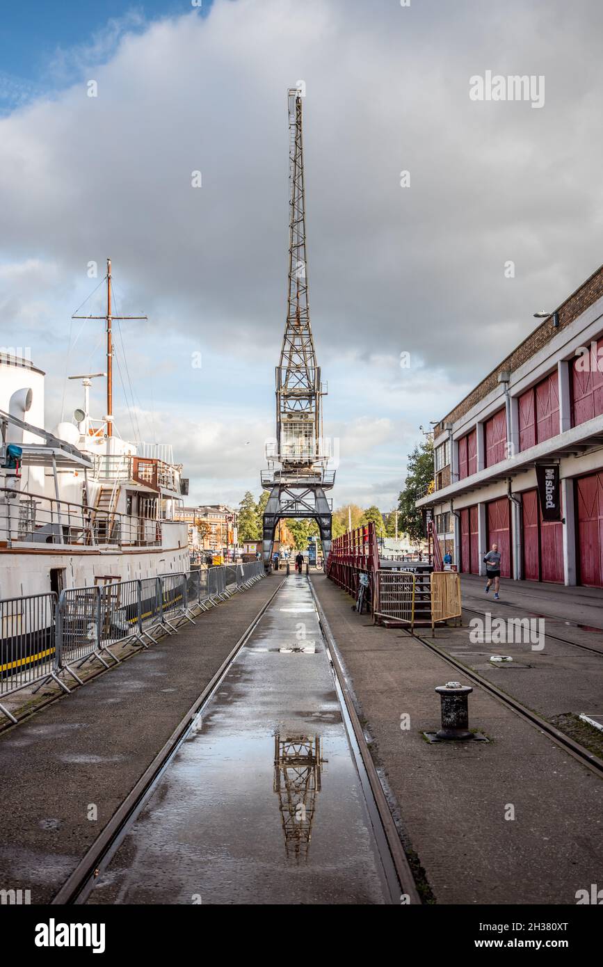 Wide angle view of tramlines and cranes at Bristol docks with the M Shed building on the right hand side Stock Photo