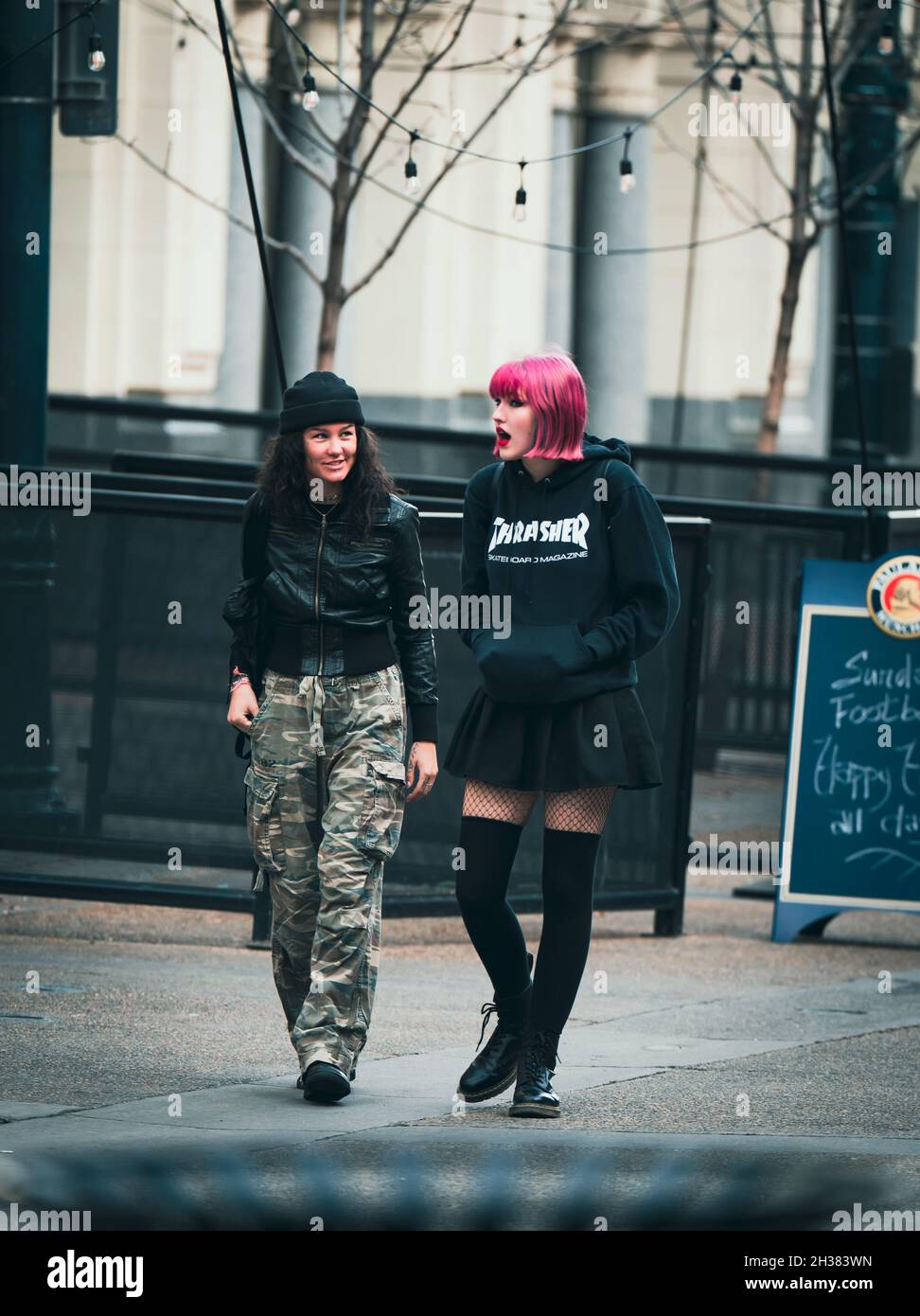 CALGARY, CANADA - Oct 24, 2021: Two women socializing as they walk downtown. Stock Photo