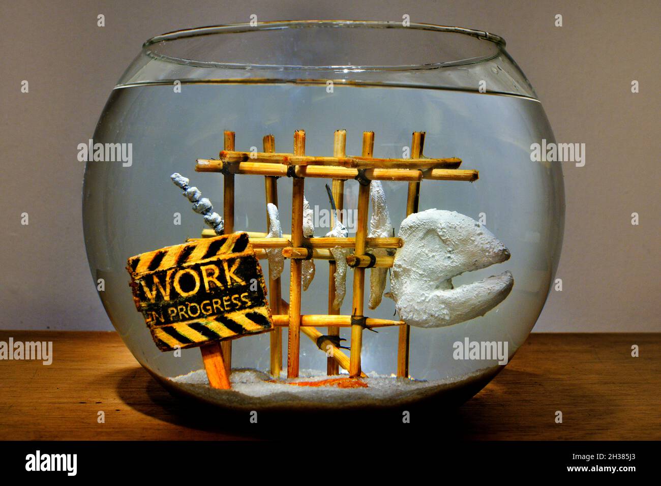 Aquarium bow with a work in progress sign by an unfinished art sculpture of a fish skeleton, Stock Photo