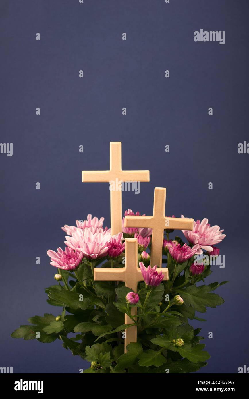 Composition of flowers and wooden cross for all souls day. Also