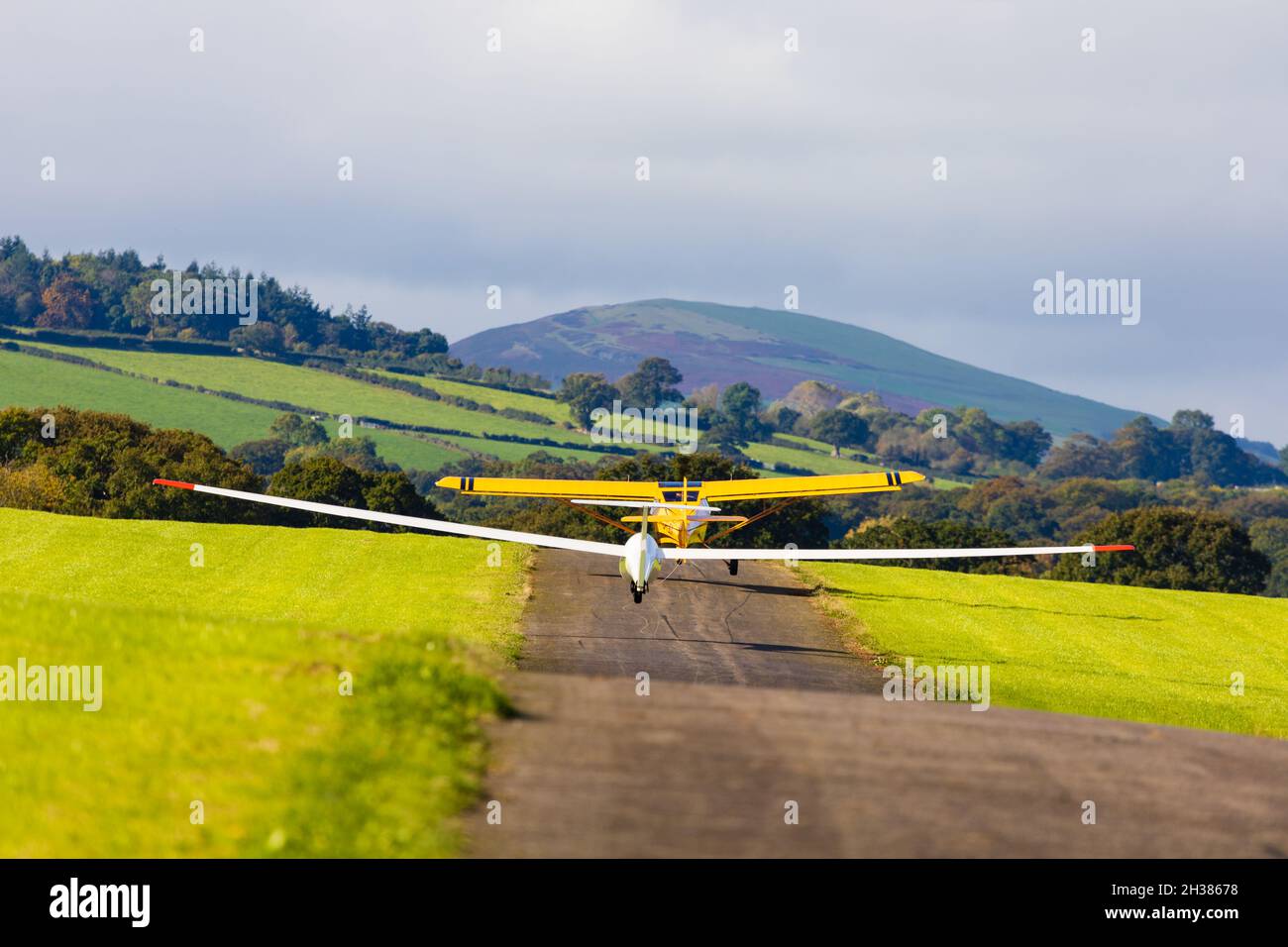 A Glaser-Dirks DG200 glider on aerotow behind a Eurofox tug. Lleweni Parc gliding site. Denbighshire, Wales. Stock Photo