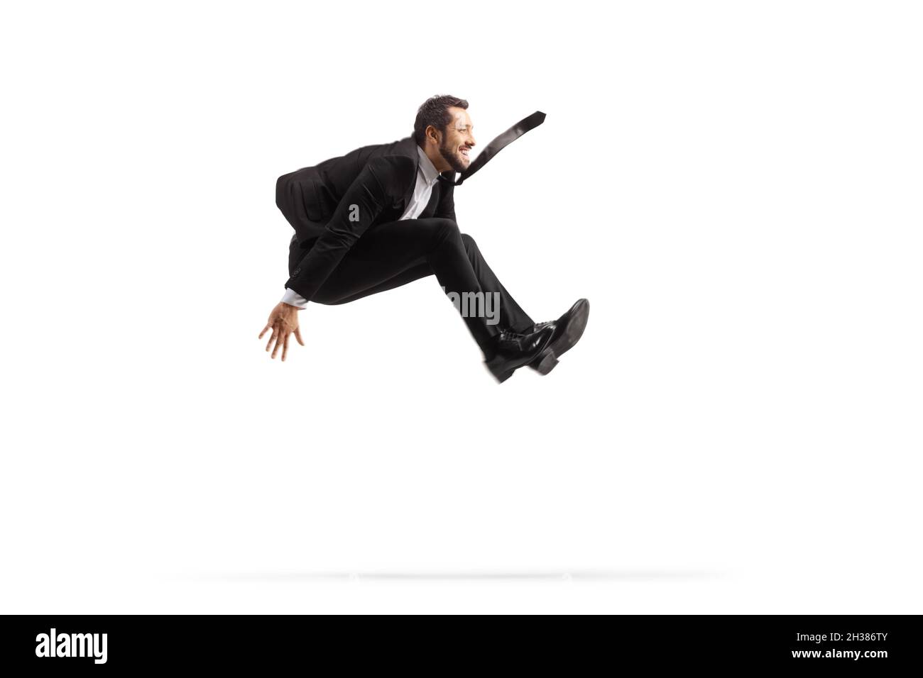 Profile shot of a businessman jumping isolated on white background Stock Photo
