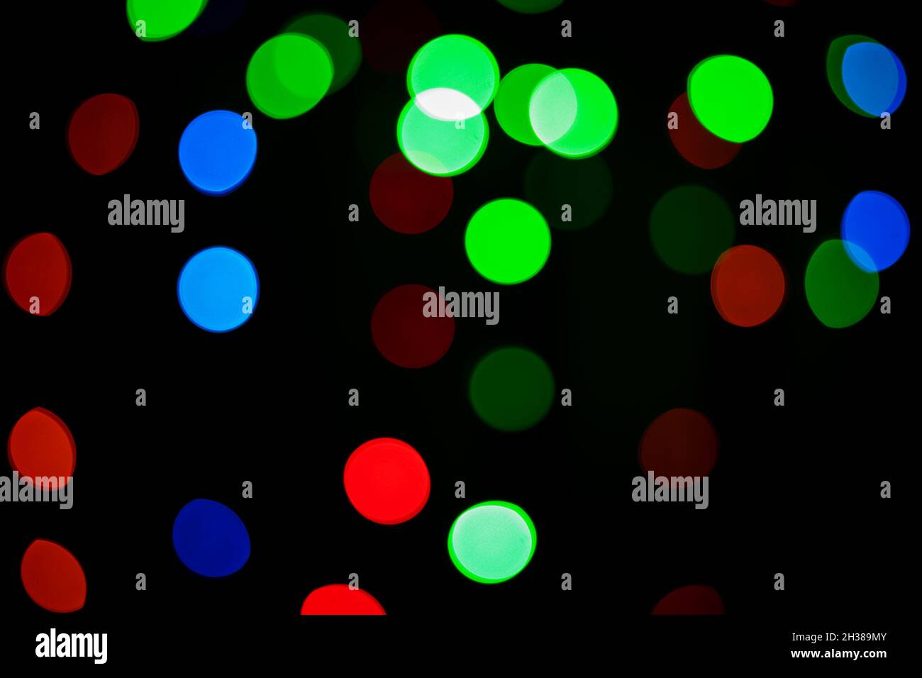 Multicolored bokeh circles on a dark background. Defocusing effect. Decorative background Stock Photo