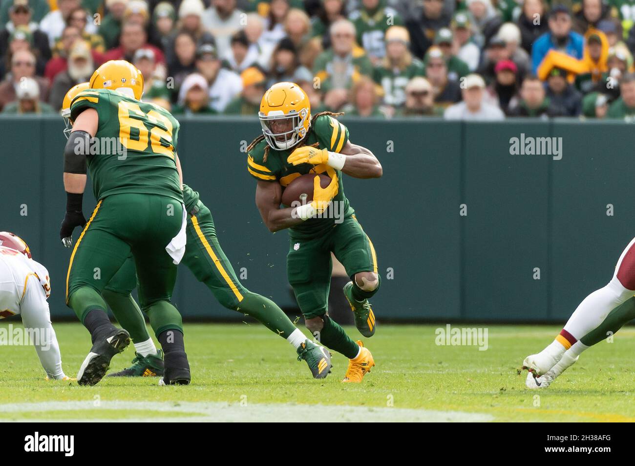 Green Bay, Wisconsin, USA. 24th Oct, 2021. Green Bay Packers running back  Aaron Jones #33 runs with the ball during NFL football game between the  Washington Football Team and the Green Bay