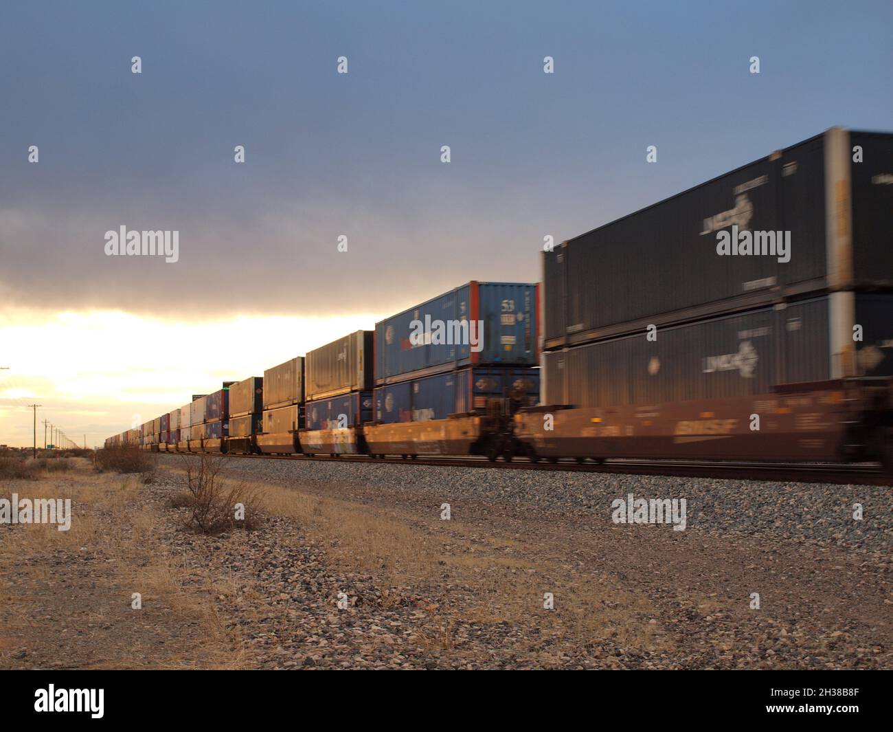 Union Pacific train through the American Southwest at Deming, New Mexico. Both enclosed auto carriers and containers are shown heading west at speed. Stock Photo