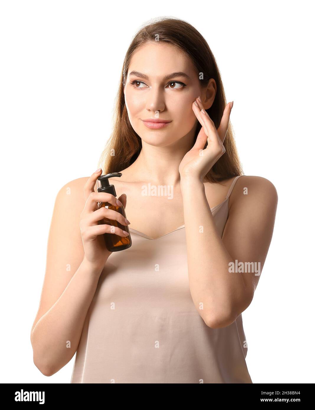 Young woman applying natural essential oil on face Stock Photo Alamy