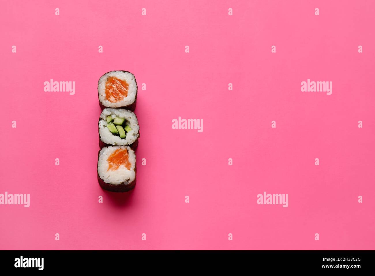 Delicious salmon and cucumber maki sushi on color background Stock Photo -  Alamy