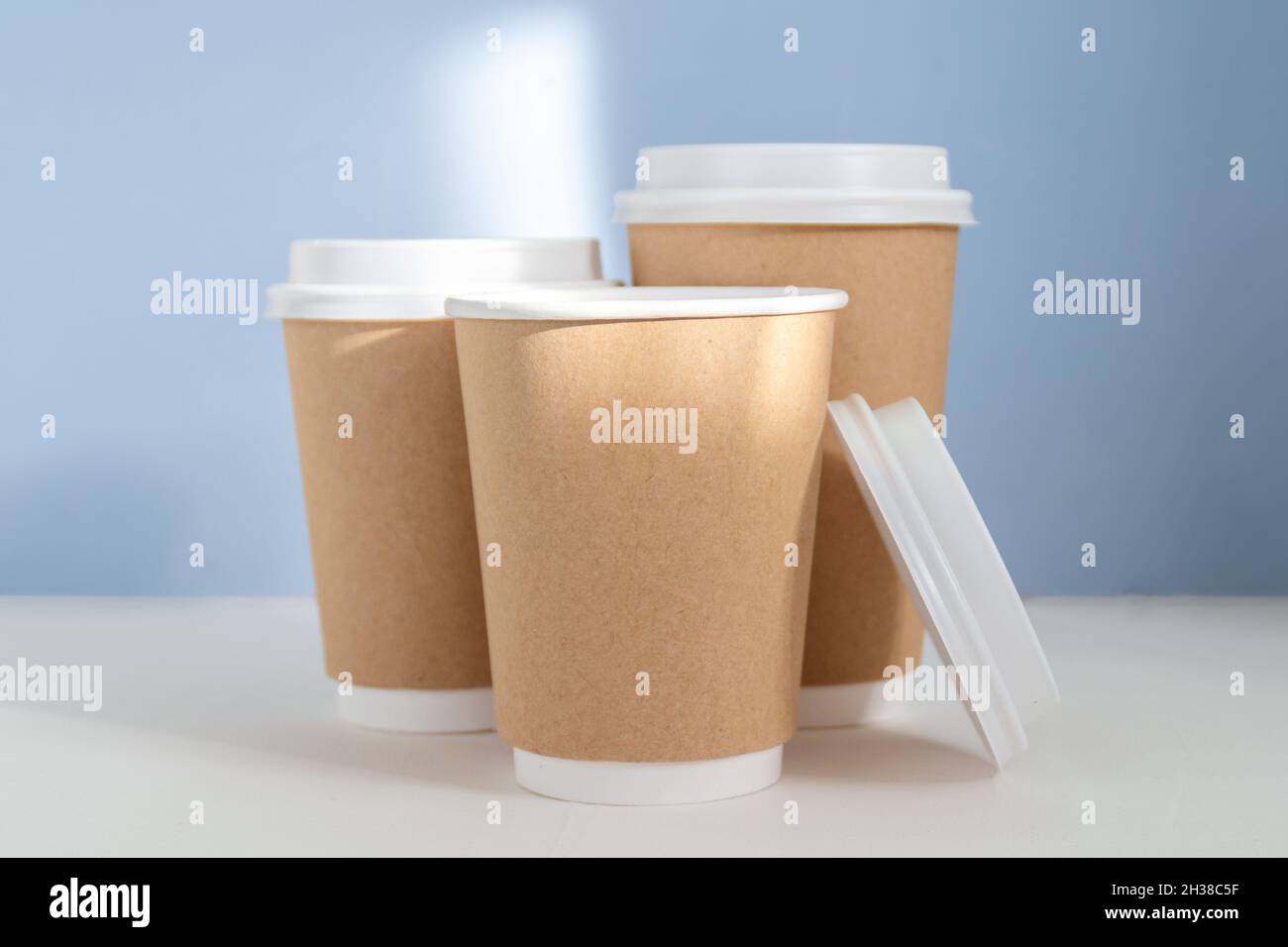 group of paper cups against blue background, greenwashing concept Stock ...