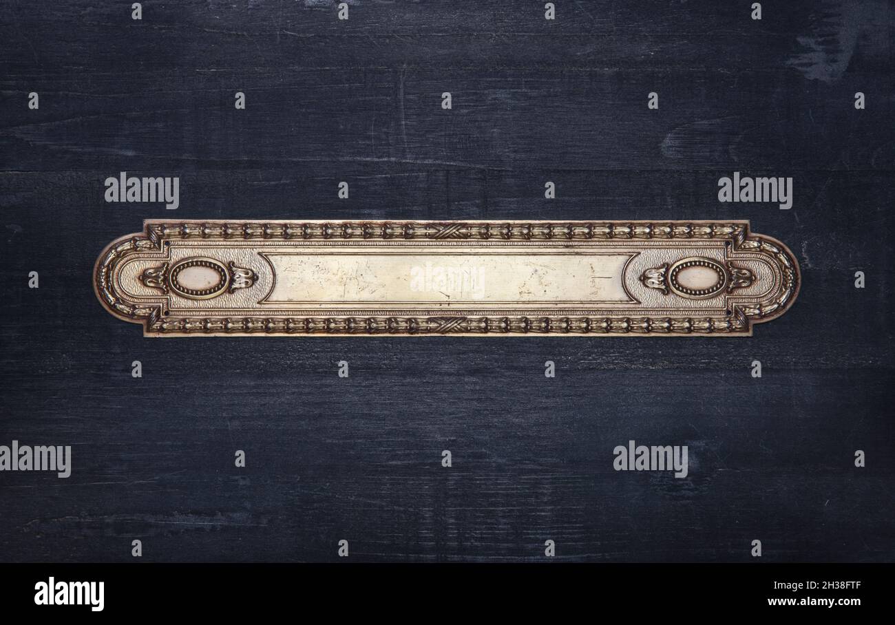 Ornate victorian metal frame on a black wood background Stock Photo