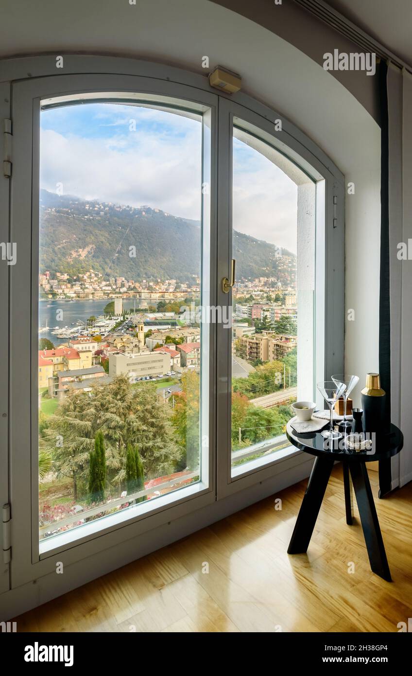 The window with a view of the lake and the city of Como, Italy Stock Photo