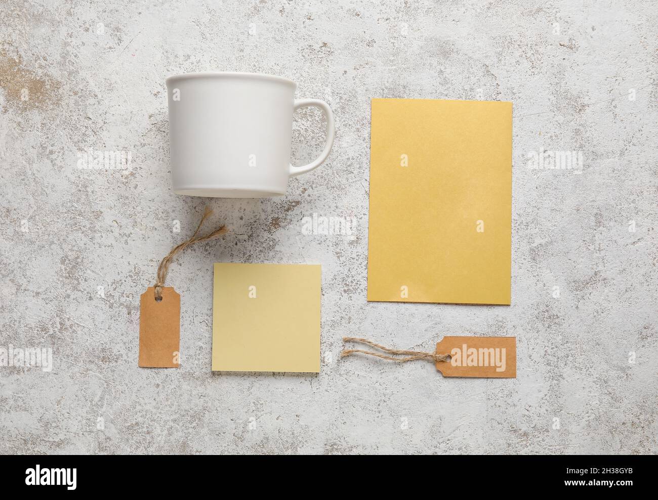 Composition with blank cup, cards and tags on light background Stock Photo
