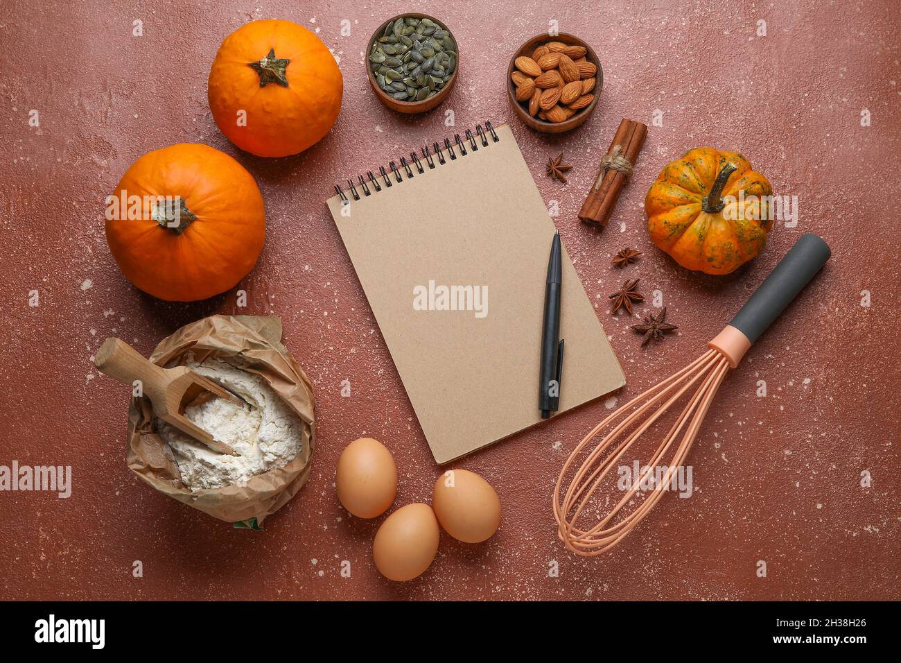 Ingredients for preparing pumpkin pie and notebook on table Stock Photo